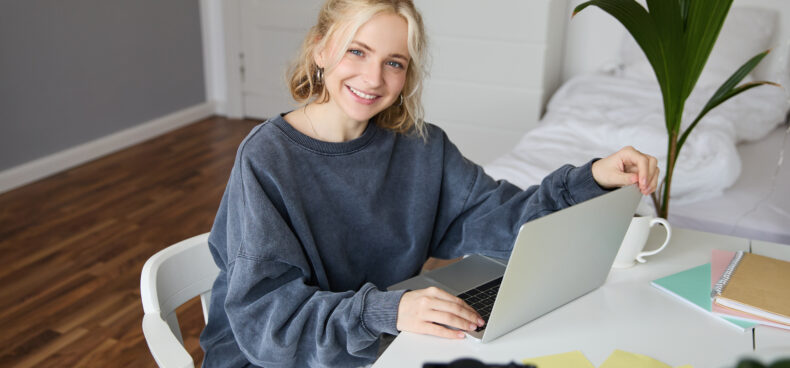 Portrait of young beautiful woman, social media influencer, recording video tutorial, lifestyle vlog, creating content in her room using digital camera